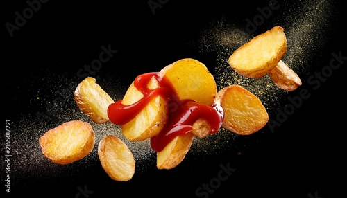 flying fried potatoes with ketchup splash