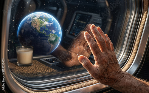 Elderly person's hand touching a spaceship window, viewing earth from orbit