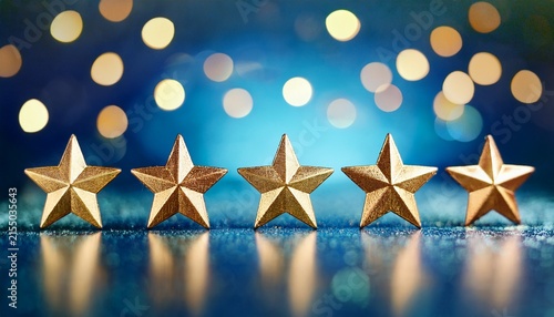 five gold stars in a row on a blue bokeh background symbolizing excellence and customer satisfaction