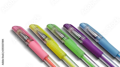 Obraz na płótnie Closeup view of five colorful ballpoint gel pens with transparent barrels and textured grips in pink, yellow, green, purple, and blue, arranged diagonally and isolated on white background