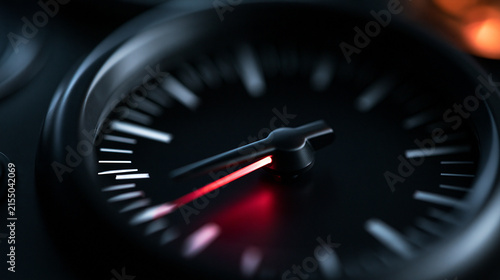 Analog Gauge Dial with Illuminated Red Needle Close Up