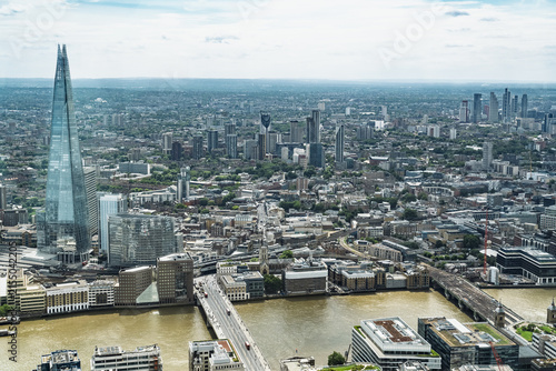 View of The Shard skyscraper towering over the River Thames and the urban landscape of the city in London, England, United Kingdom.