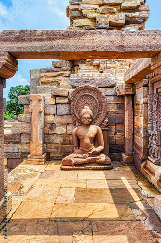 Ancient Seated Buddha Sculpture with Halo at Sanchi Archaeological Site, India