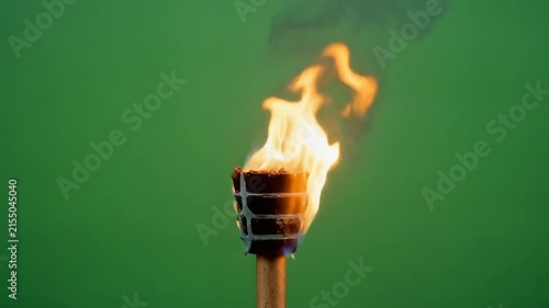 Burning wooden torch flame isolated on green screen for visual effects compositing