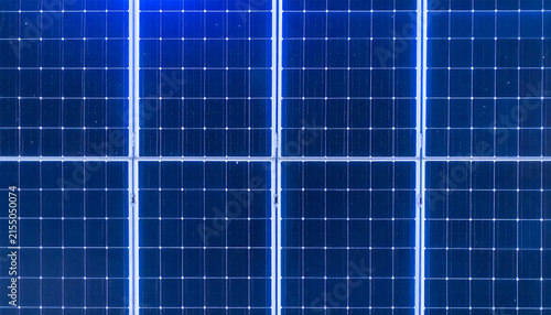 Solar panels background featuring blue photovoltaic cells arranged in a grid pattern for renewable energy and sustainable power generation concepts