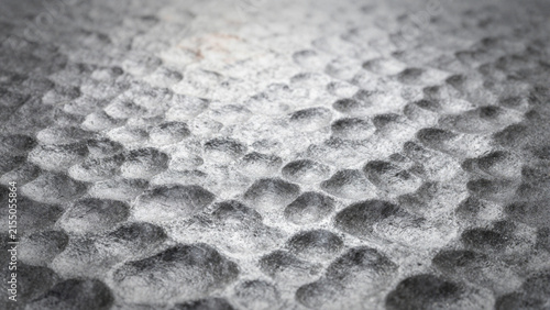 textured metalic surface with a pattern of concave holes