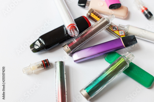 Canvas Print Scattered colorful disposable vapes and pods featuring toxic warning symbols, illustrating nicotine addiction, health hazards, and lung damage caused by modern electronic cigarettes