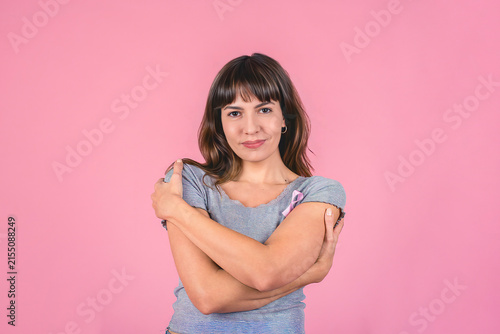 Self love and care concept with woman wearing pink ribbon for breast cancer awareness