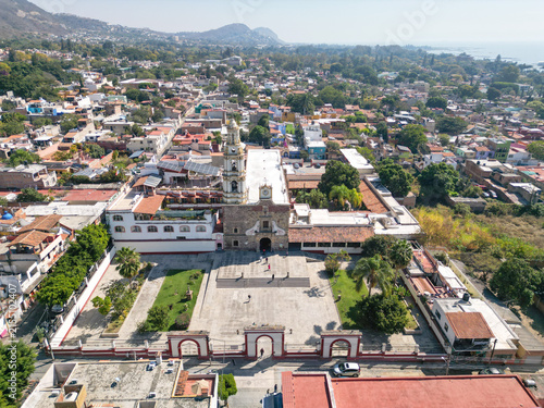 Ajijic, Mexico - January 26 2025: Drone view of Saint Andrew Apostle Parish Church and plaza, Ajijic, Jalisco, Mexico. Town by Lake Chapala and mountains