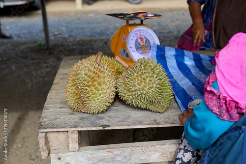 Fresh durian fruit for sale at outdoor market
