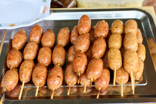Grilled Thai sausage skewers on a metal tray