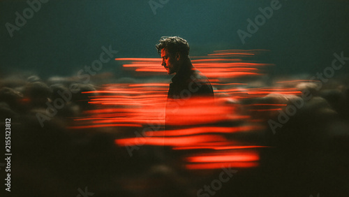Loneliness and Anxiety Concept with Man Standing Still Among Blurred Crowd Under Red Light