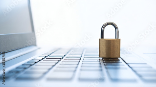 Padlock standing on laptop keyboard symbolizing cybersecurity and data protection