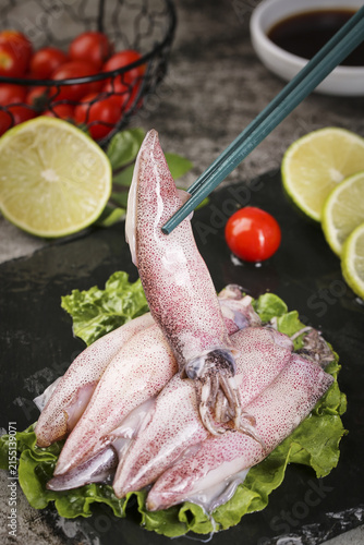 Fresh Raw Squid Seafood with Lime and Vegetables on Slate Board - Asian Cuisine Ingredients