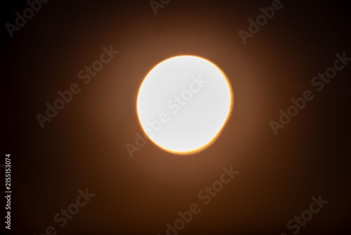 blurred partial solar eclipse glowing in dark sky, astronomical phenomenon, celestial alignment, moon crossing sun disc, stellar event, space science observation, Ghost cosmic mystery, orbital motion