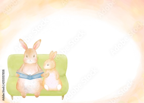 ソファで絵本を読むうさぎの親子の水彩フレーム背景。ふんわり暖かい親子の愛情を感じる読み聞かせタイム。