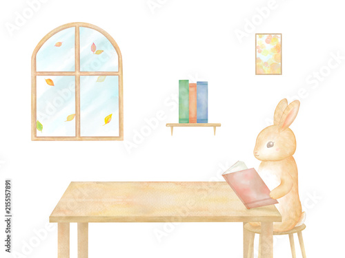 机に向かって熱心に本を読む愛らしいうさぎの水彩イラスト。