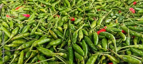 Bild auf Leinwand Top view macro texture background of small red and green hot chilies at local ma