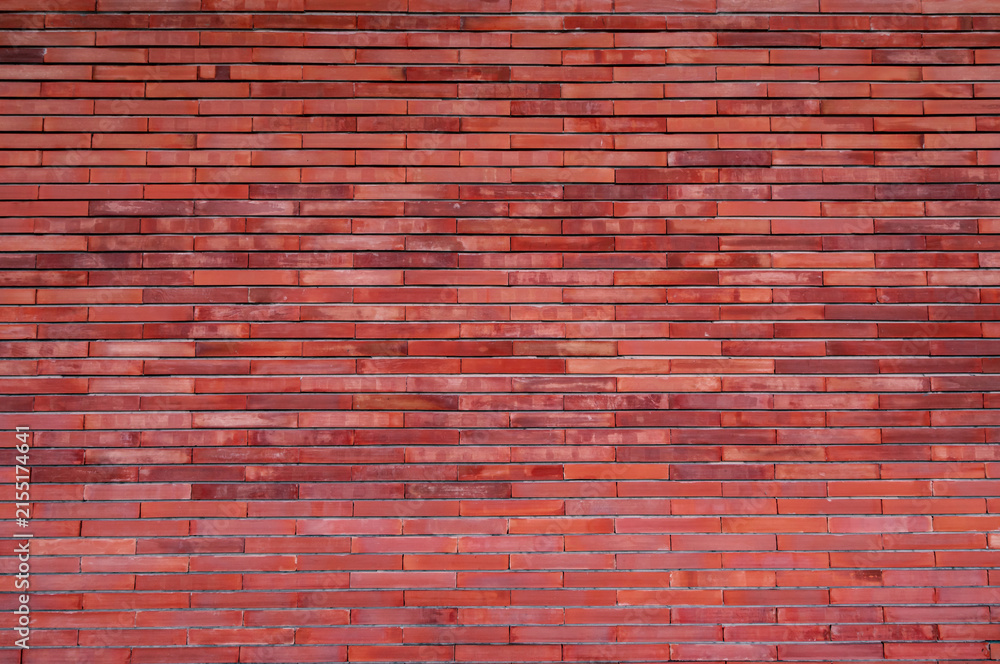 Fototapeta premium Modern red brick wall texture with clean horizontal masonry pattern, architectural construction background featuring natural clay material for graphic design, website layouts and commercial use.
