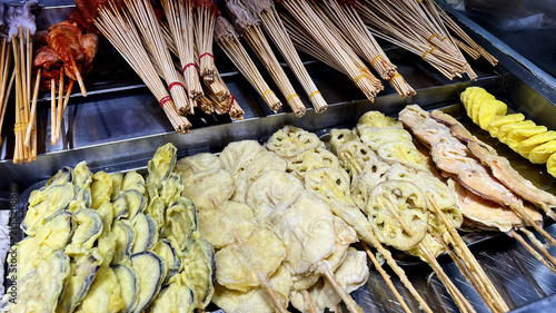 Fotografie Assorted Fried Skewers at Street Food Stall
