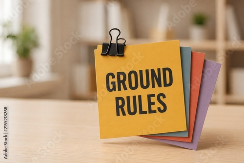Ground Rules on Sticky Notes: A close-up shot features a stack of colorful sticky notes, with the top yellow note clearly displaying GROUND RULES in bold black lettering, held by a binder clip.