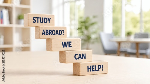 Study Abroad Assistance: Wooden blocks spell out STUDY ABROAD? WE CAN HELP! creating a visual staircase of opportunity, suggesting guidance and support for international education.