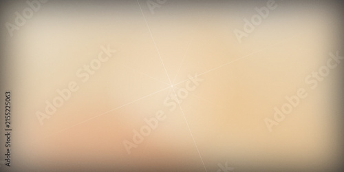 Abstract beige background with light soft lens flare and vignetting blur.