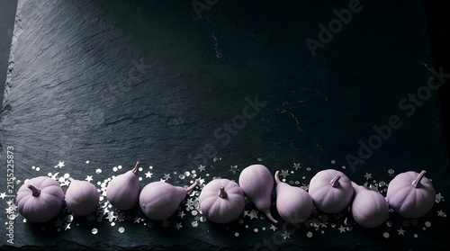 A captivating and eerie still life composition featuring a row of pink baby chicks dramatically lit against a dark textured and mysterious background evoking