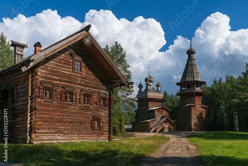 The Church of the Ascension with a bell tower against the backdrop of the estate of a wealthy peasant in the Kargopol‑Onega sector of the Malye Korely Museum‑Reserve, Arkhangelsk Oblast, Russia