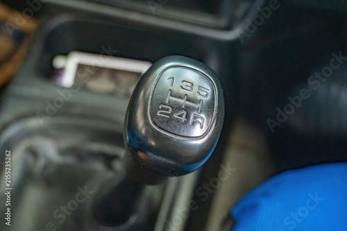 Obraz na plátně Close up of a manual car gear shift knob and stick lever in the interior cabin, reflecting modern automotive transport challenges and trends