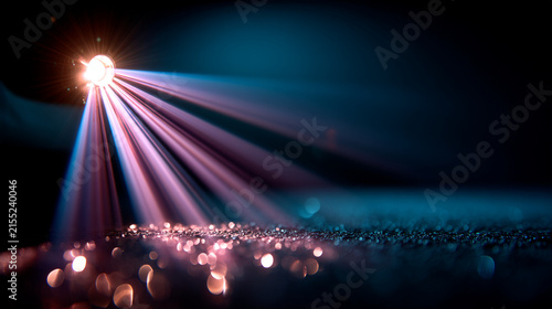 Cinematic light beam from a spotlight illuminating dark space with bokeh particles, spotlight