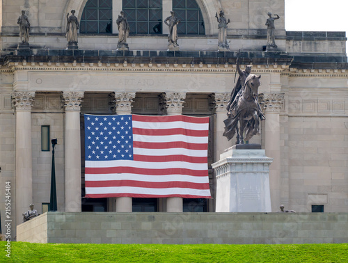 St. Louis, Missouri, United States - 07 August 2026: View of the Saint Louis Art Museum facade with the Apotheosis of Saint Louis statue and a large American flag.
