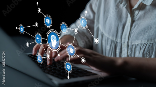 Canvastavla This conceptual image illustrates the fusion of technology and brainpower, highlighting online learning and digital interaction with a laptop and various icons