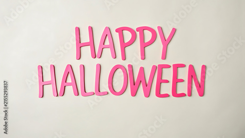Handwritten Happy Halloween greeting card with pink chalk text on white background for festive party invites