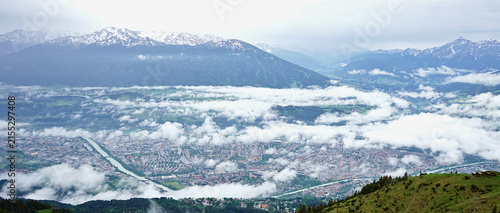 Spectacular view from above of Innsbruck city with alps mountain range.