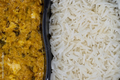 Chicken curry and rice tv dinner spicy food in plastic container flat lay closeup.	