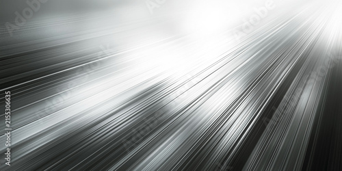Black and white image showing light shining on a curved metal surface.
