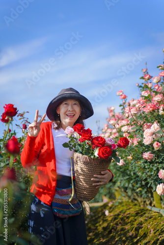 Rose Garden Asian Woman Enjoying Colorful Flowers with Mountain Landscape in Chiang Mai, Northern Thailand