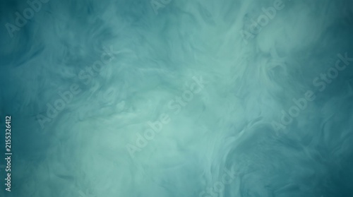 Swirling blue and teal clouds resembling underwater currents, symbolizing depth, tranquility, and abstract motion.