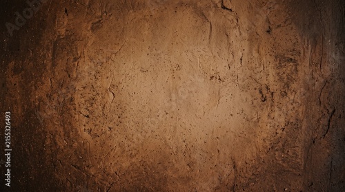 Weathered brown clay wall with cracks and texture, symbolizing age, resilience, and natural beauty.