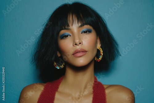 Portrait of a model with blue eyeshadow on a blue background, cosmetics for women, skincare products, made-up girl. High quality photo