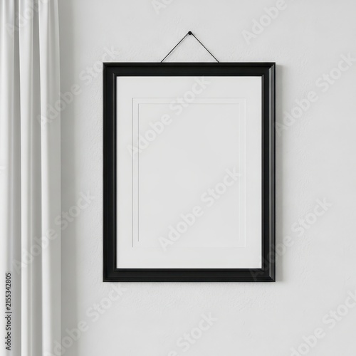 Empty black picture frame hanging on wall with rope