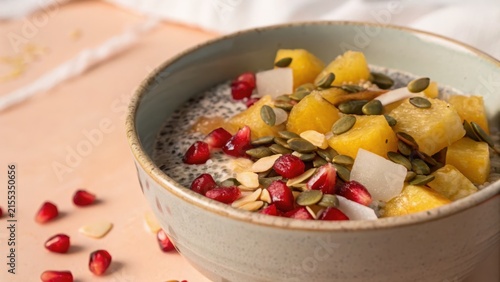 Chia pudding with pineapple and pomegranate toppings in a bowl