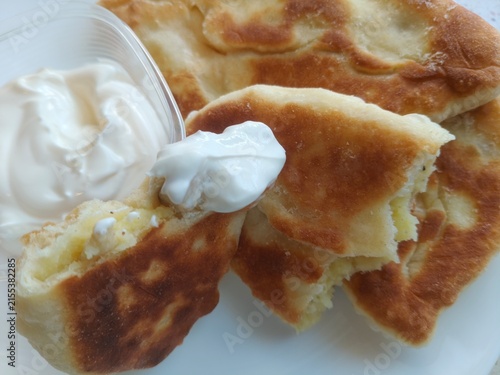 Bild auf Leinwand Cut-open homemade pie revealing savory potato and mushroom filling, rustic traditional food