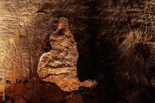 Illuminated shape on the wall inside the Valporquero Cave, Vegacervera, León, Spain.