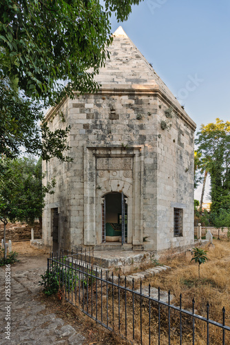 Historic stone Tomb of Zincirkiran Mehmet Bey located beside the Mawlawi Lodge in the city of Antalya, Turkey, featuring traditional architectural details and a surrounding garden area