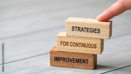 Hand arranging strategy blocks for continuous improvement, progress and business development