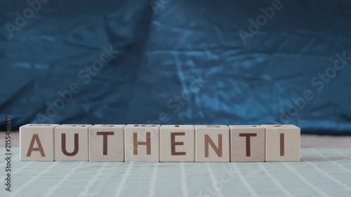 authentic, motivational word, laying out  by hand from letters on wooden cubes, slow motion
