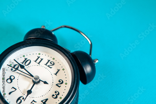 Canvas Print alarm clock on blue background. Time is money concept.