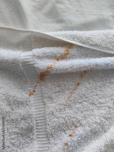 rust on a white towel. rust-stained towel. dirty towel